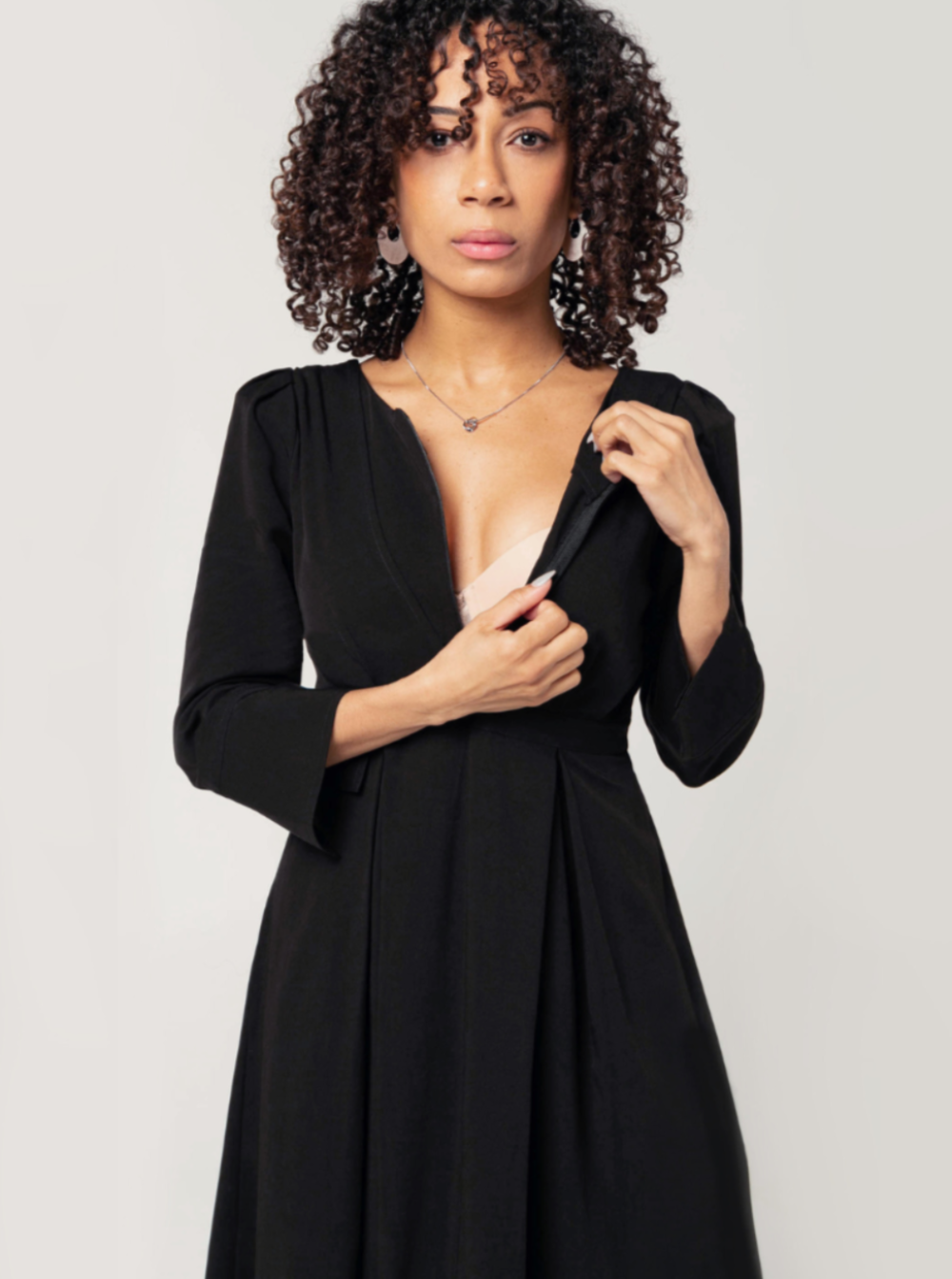 Black maternity and nursing dresses by MARION. Sustainable TENCEL empire waist style with deep pockets and full feminine skirt. Breastfeeding friendly with 3/4 sleeves and elegant cuff detail. Petite sizing also available. Maternity workwear favorite.