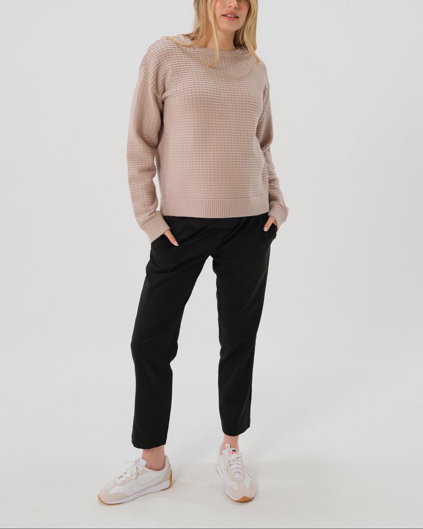 Black maternity pants, under belly style, cut in all-season wool blend with hidden flexible waist adjustment, deep pockets, and stylish straight leg. Maternity trousers cropped for tall mamas and full length for petite pregnant women. Postpartum friendly women's wear for business, wedding guest, dinner, and occasion.