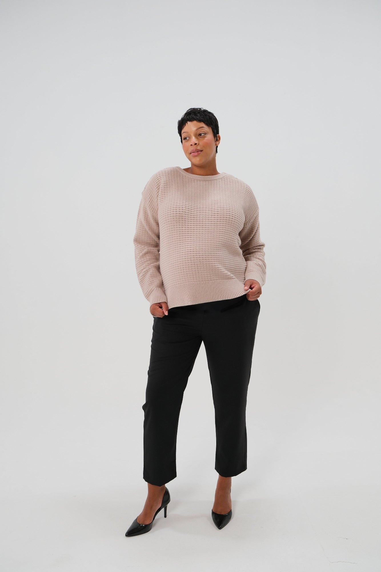 Black maternity pants for work, under belly style, cut in all-season wool blend with hidden flexible waist adjustment, deep pockets, and stylish straight leg. Maternity trousers cropped for tall mamas and full length for petite pregnant women. Postpartum friendly women's wear for business, wedding guest, dinner, and occasion.