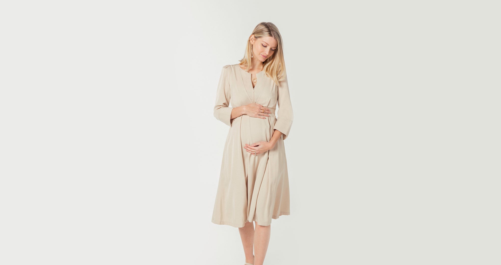 Maternity dresses and nursing dresses by MARION. Luxury baby shower dresses, wedding guest dresses, maternity sweater dresses, and breastfeeding dresses for work. 