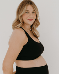 Black maternity and nursing full support sports bra with one hand breastfeeding release clips. Luxury quality fabric and stylish, flattering fit for pregnancy and postpartum. 