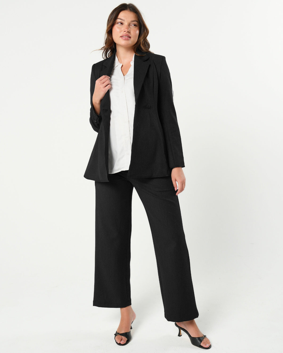 Black maternity wide leg dress pants for work with over belly band. Sustainable pregnancy business trousers cut with luxury Italian suiting fabric. Perfect maternity bottom separates for maternity pant suit.