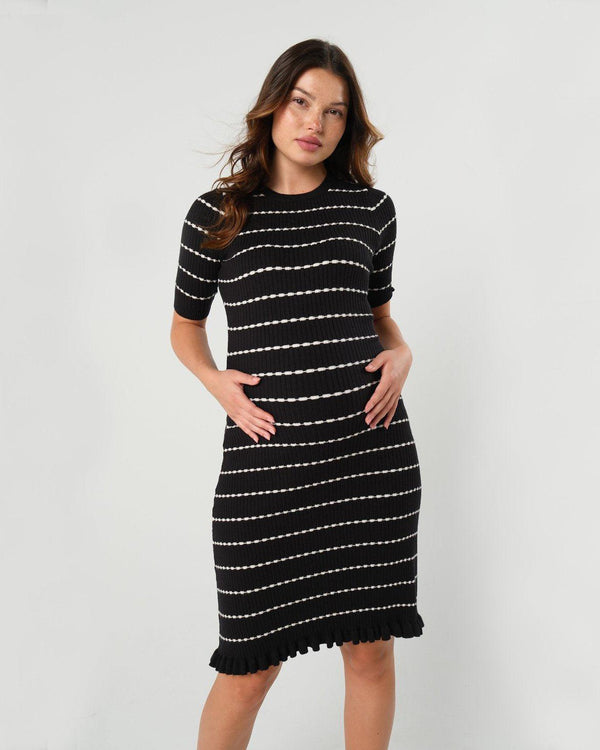 Striped knit maternity and nursing dress in black and white. Knee length three quarter sleeves with feminine hem detail. Ideal for maternity business workwear, date, church, wedding guest, brunch, and occasion. MARION luxury maternity workwear.