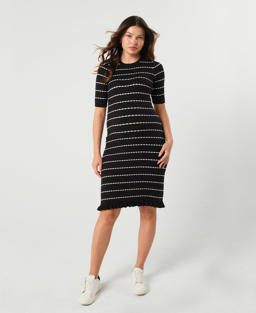 Striped knit maternity and nursing dress in black and white. Knee length three quarter sleeves with feminine hem detail. Ideal for maternity business workwear, date, church, wedding guest, brunch, and occasion. MARION luxury maternity workwear.