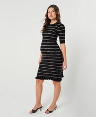 Striped knit maternity and nursing dress in black and white. Knee length three quarter sleeves with feminine hem detail. Ideal for maternity business workwear, date, church, wedding guest, brunch, and occasion. MARION luxury maternity workwear.