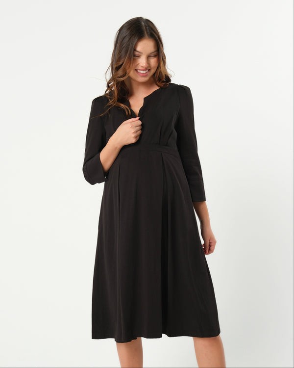 Black maternity and nursing empire dress for business, baby shower, wedding guest, party, and formal occasions. Sustainable TENCEL, zipper breastfeeding access, and full skirt with deep pockets. MARION offers the market's best maternity dresses in petite and standard sizes.