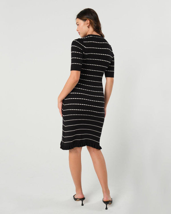 Striped knit maternity and nursing dress in black and white. Knee length three quarter sleeves with feminine hem detail. Ideal for maternity business workwear, date, church, wedding guest, brunch, and occasion. MARION luxury maternity workwear.