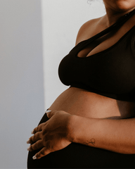 Black one-shoulder maternity and nursing sports bra and athleisure top. Luxe nylon fabric with one hand breastfeeding release clips. 