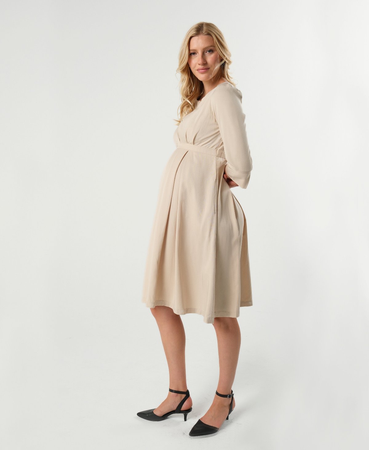 Beige maternity and nursing empire dress for business, baby shower, wedding guest, party, and formal occasions. Sustainable TENCEL, zipper breastfeeding access, and full skirt with deep pockets. Petite and standard sizes.