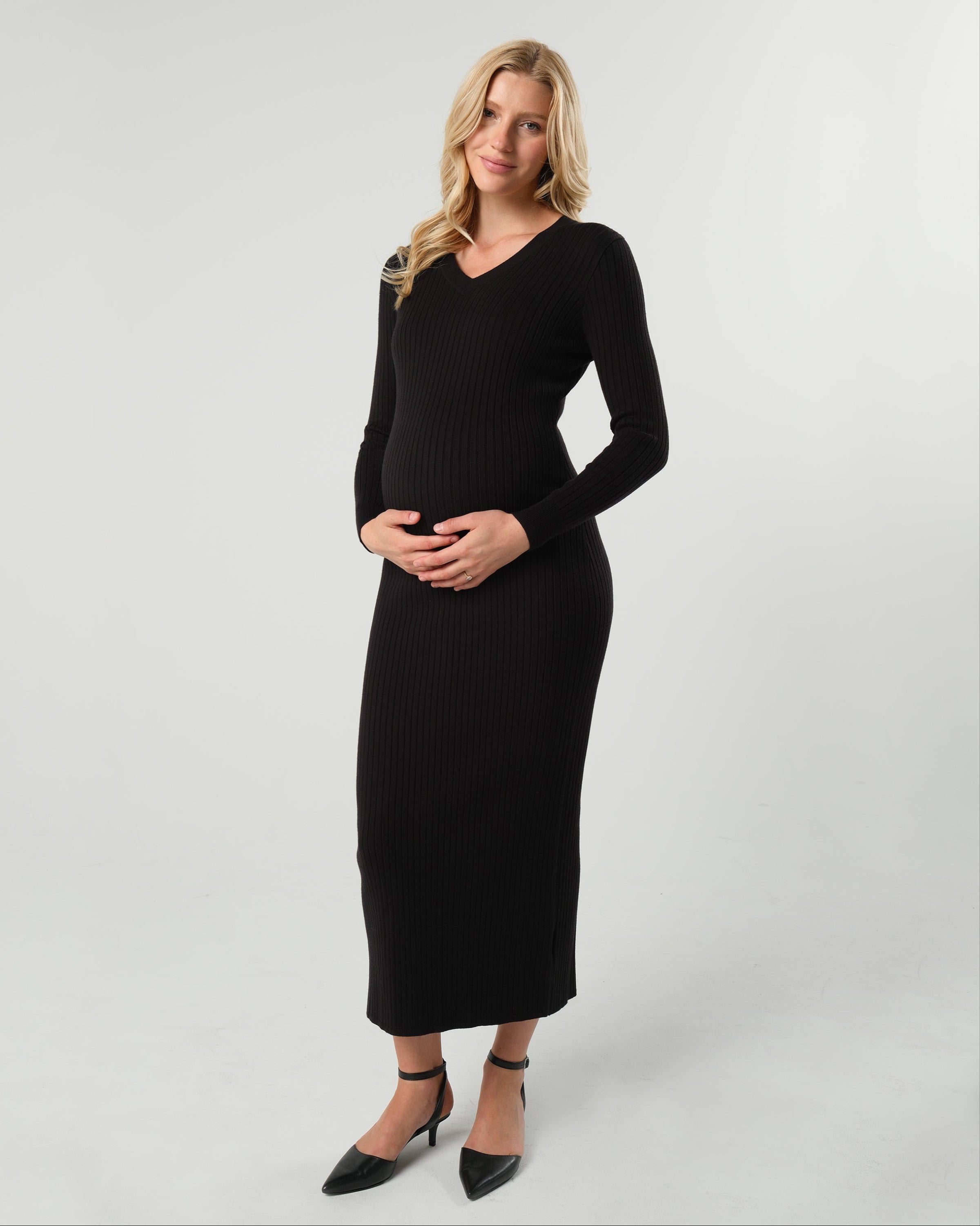 Black maternity sweater dress with discreet nursing access. Long knit maternity office wear dress is petite friendly and fits tall mamas like a midi dress. Perfect for baby shower, maternity guest, or business attire. MARION offers the best in luxury maternity fashion. 