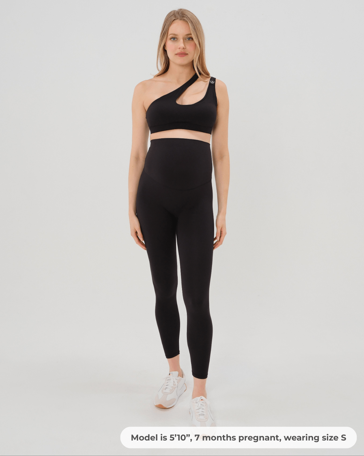 Pregnant woman wearing premium black AXK maternity leggings with flattering scrunch butt and matching high-impact, racerback nursing sports bra. Best reviewed high quality maternity athletic and activewear for 2026, perfect for running, pregnancy yoga, walking, and loungewear. Available in standard and plus sizes, petite and tall friendly.