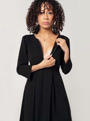 Black maternity and nursing dresses by MARION. Sustainable TENCEL empire waist style with deep pockets and full feminine skirt. Breastfeeding friendly with 3/4 sleeves and elegant cuff detail. Petite sizing also available. Maternity workwear favorite.