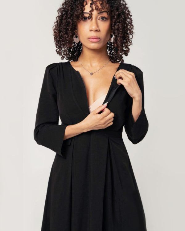 Black maternity and nursing dresses by MARION. Sustainable TENCEL empire waist style with deep pockets and full feminine skirt. Breastfeeding friendly with 3/4 sleeves and elegant cuff detail. Petite sizing also available. Maternity workwear favorite.