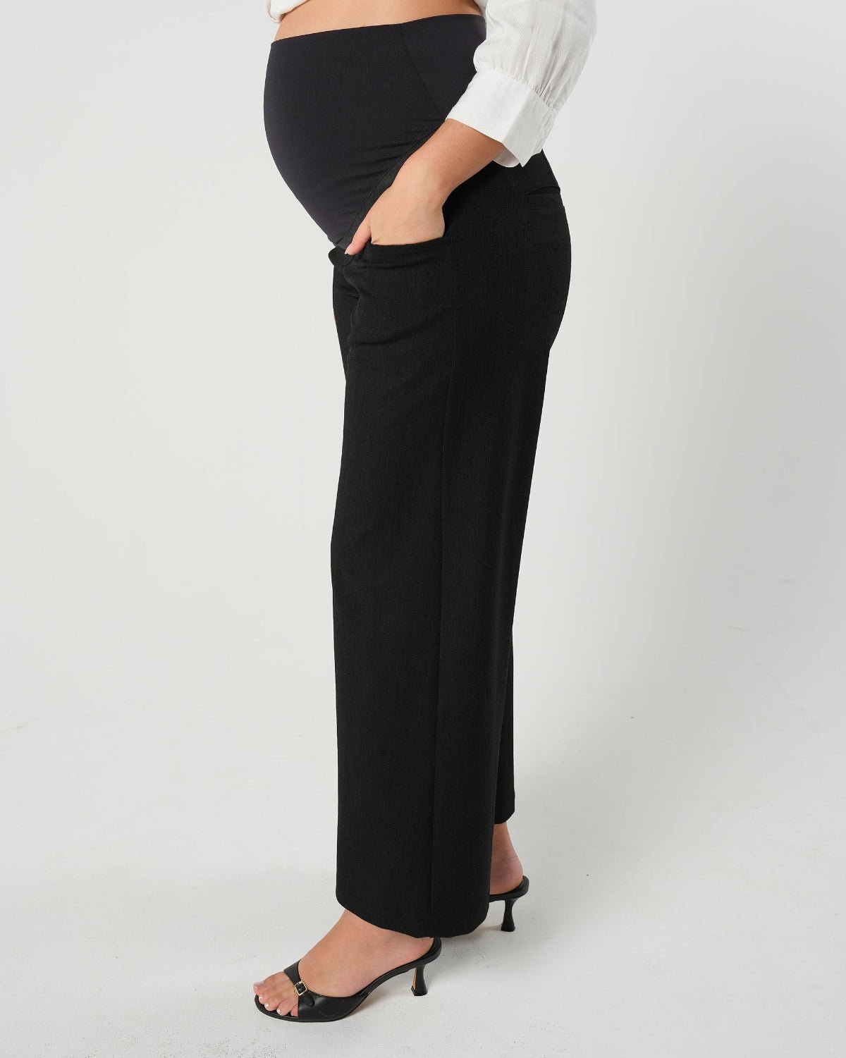Black maternity wide leg dress pants for work with over belly band, boasting glowing 5-star customer reviews. Our best  selling sustainable pregnancy business trousers for 2026 are cut with luxury sustainable Italian suiting fabric. These pants are perfect separates paired with our Nathalie blazer for a stylish pant suit, or worn with our viral satin shell top for business casual style. 