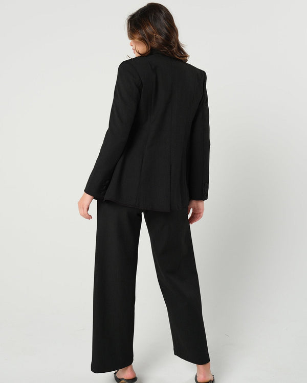 Black maternity wide leg dress pant with over belly band. Sustainable pregnancy business trousers cut with Italian suiting fabric. 