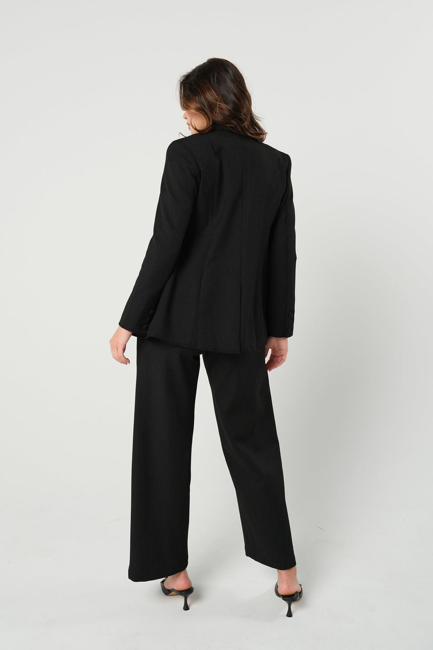 Black maternity wide leg dress pant with over belly band. Sustainable pregnancy business trousers cut with Italian suiting fabric. 