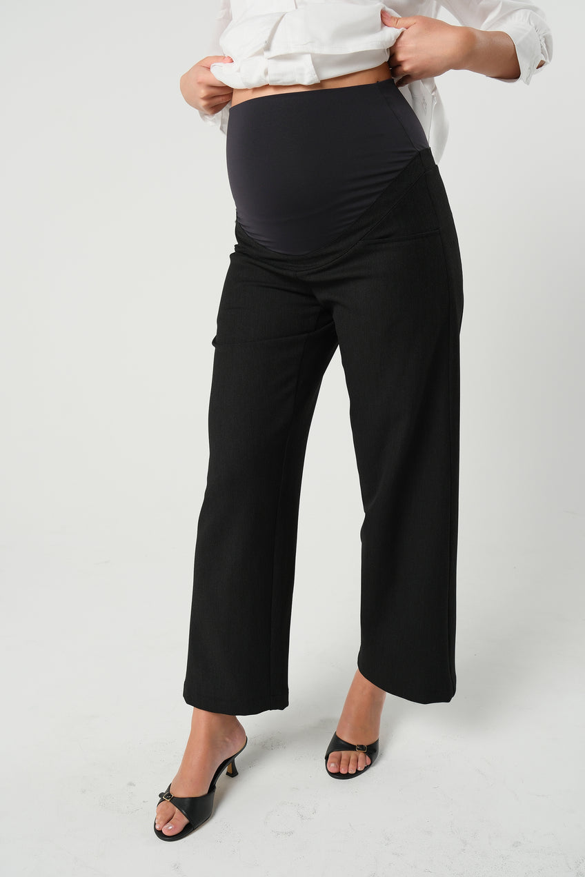 Black maternity wide leg dress pant with over belly band. Sustainable pregnancy business trousers cut with Italian suiting fabric. 