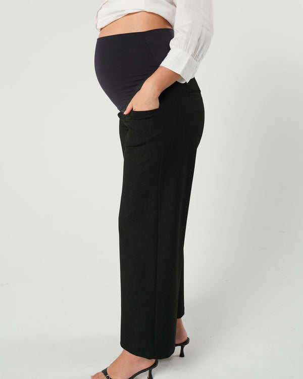 Black maternity wide leg dress pant with over belly band. Sustainable pregnancy business trousers cut with Italian suiting fabric. 