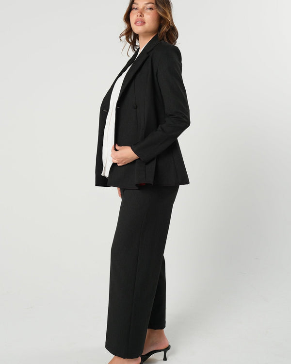 Black maternity wide leg dress pant with over belly band. Sustainable pregnancy business trousers cut with Italian suiting fabric. 