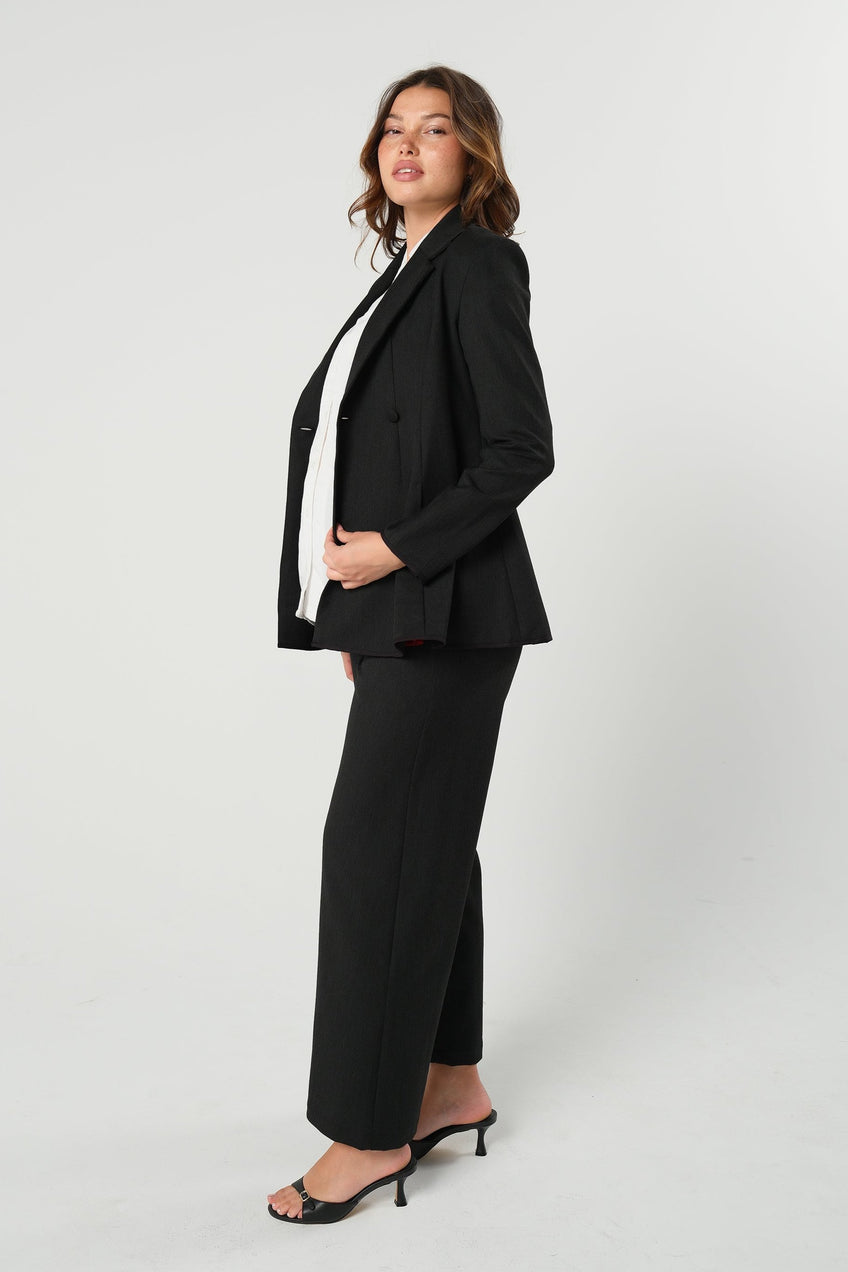 Black maternity wide leg dress pant with over belly band. Sustainable pregnancy business trousers cut with Italian suiting fabric. 