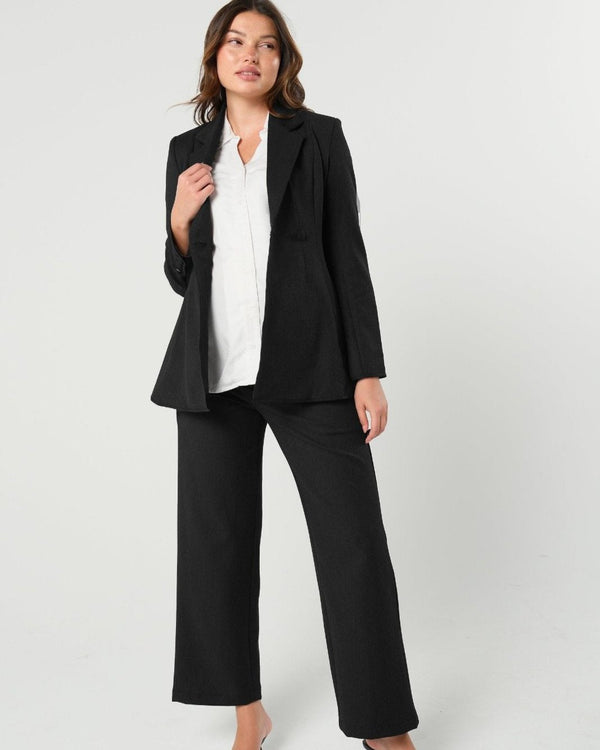 Black maternity wide leg dress pant with over belly band. Sustainable pregnancy business trousers cut with Italian suiting fabric. 