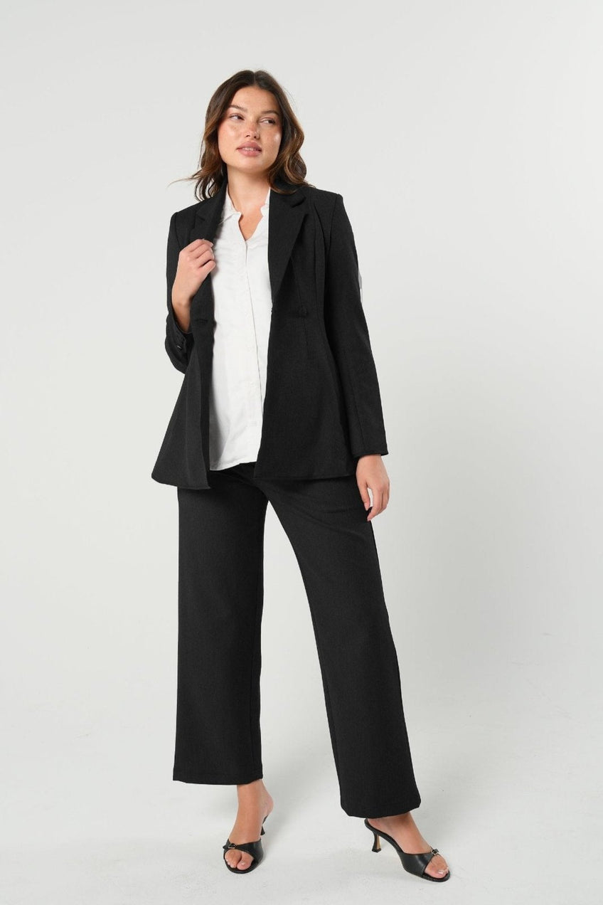 Black maternity wide leg dress pant with over belly band. Sustainable pregnancy business trousers cut with Italian suiting fabric. 