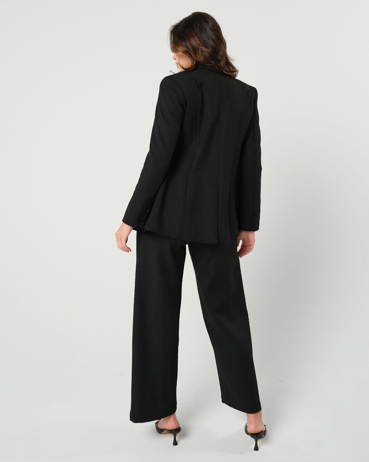 Black maternity wide leg dress pants for work with over belly band, boasting glowing 5-star customer reviews. Our best  selling sustainable pregnancy business trousers for 2026 are cut with luxury sustainable Italian suiting fabric. These pants are perfect separates paired with our Nathalie blazer for a stylish pant suit, or worn with our viral satin shell top for business casual style. 
