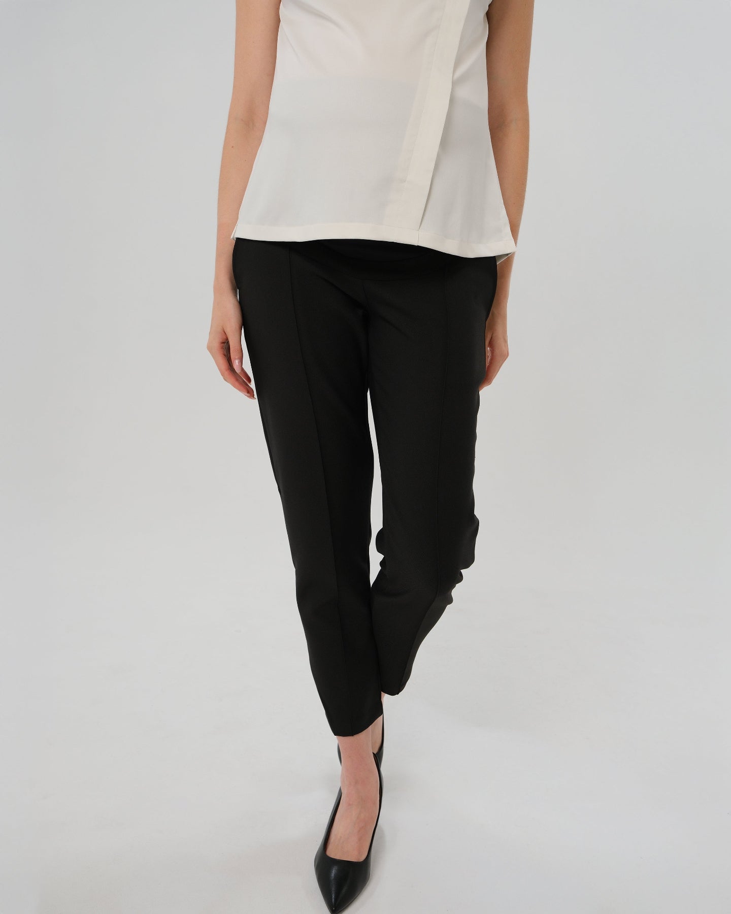 Best selling formal black maternity work pants by MARION. These 2026 core season slacks for the office, courtroom, or business casual needs feature a tailored, slimming design and are cut with luxury Italian stretch suiting fabric. Shop our petite and tall friendly, sustainable, and washable pregnancy suiting trousers that earn glowing 5-star customer reviews. Premium maternity business attire. 