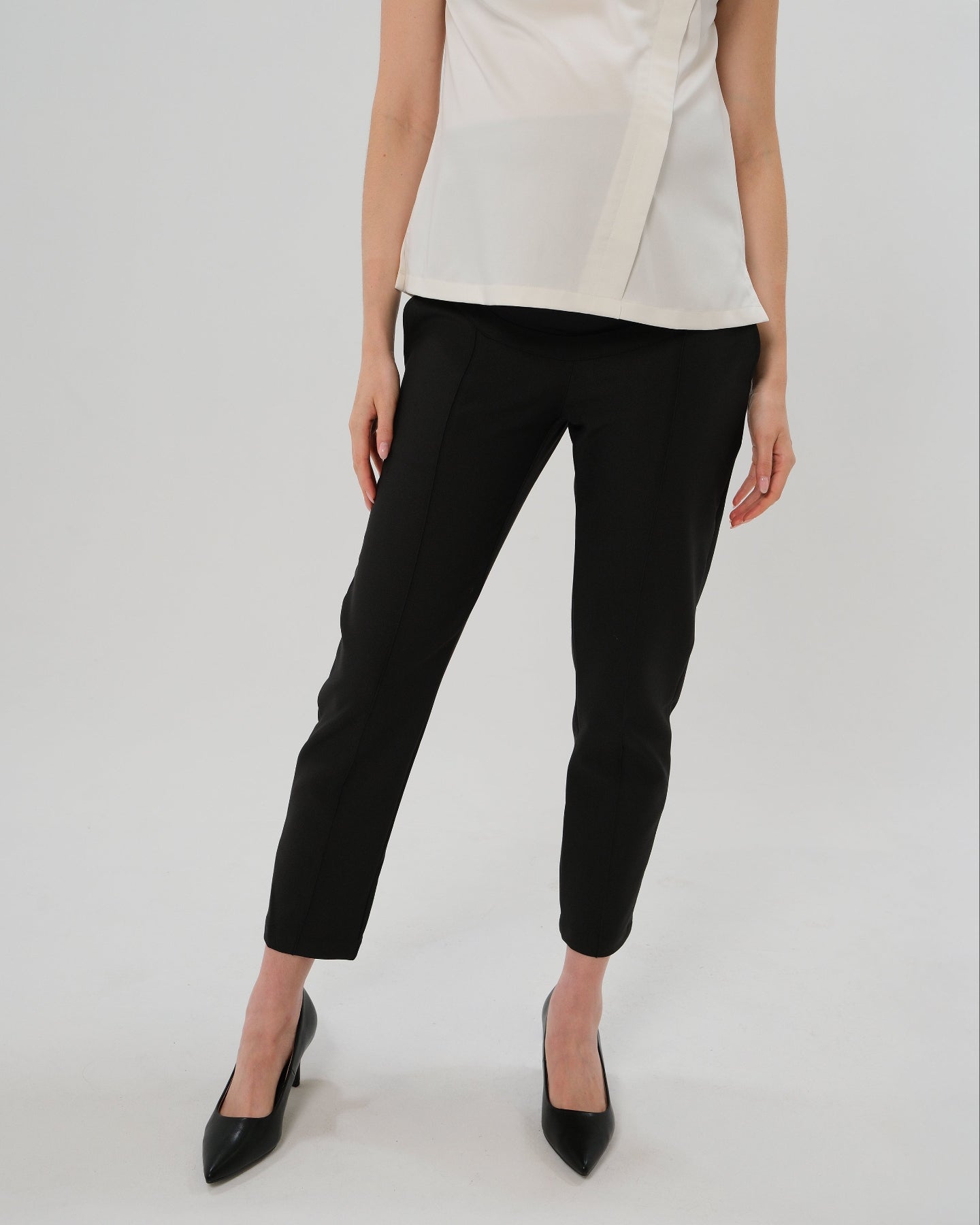 Best selling formal black maternity work pants by MARION. These 2026 core season slacks for the office, courtroom, or business casual needs feature a tailored, slimming design and are cut with luxury Italian stretch suiting fabric. Shop our petite and tall friendly, sustainable, and washable pregnancy suiting trousers that earn glowing 5-star customer reviews. Premium maternity business attire. 