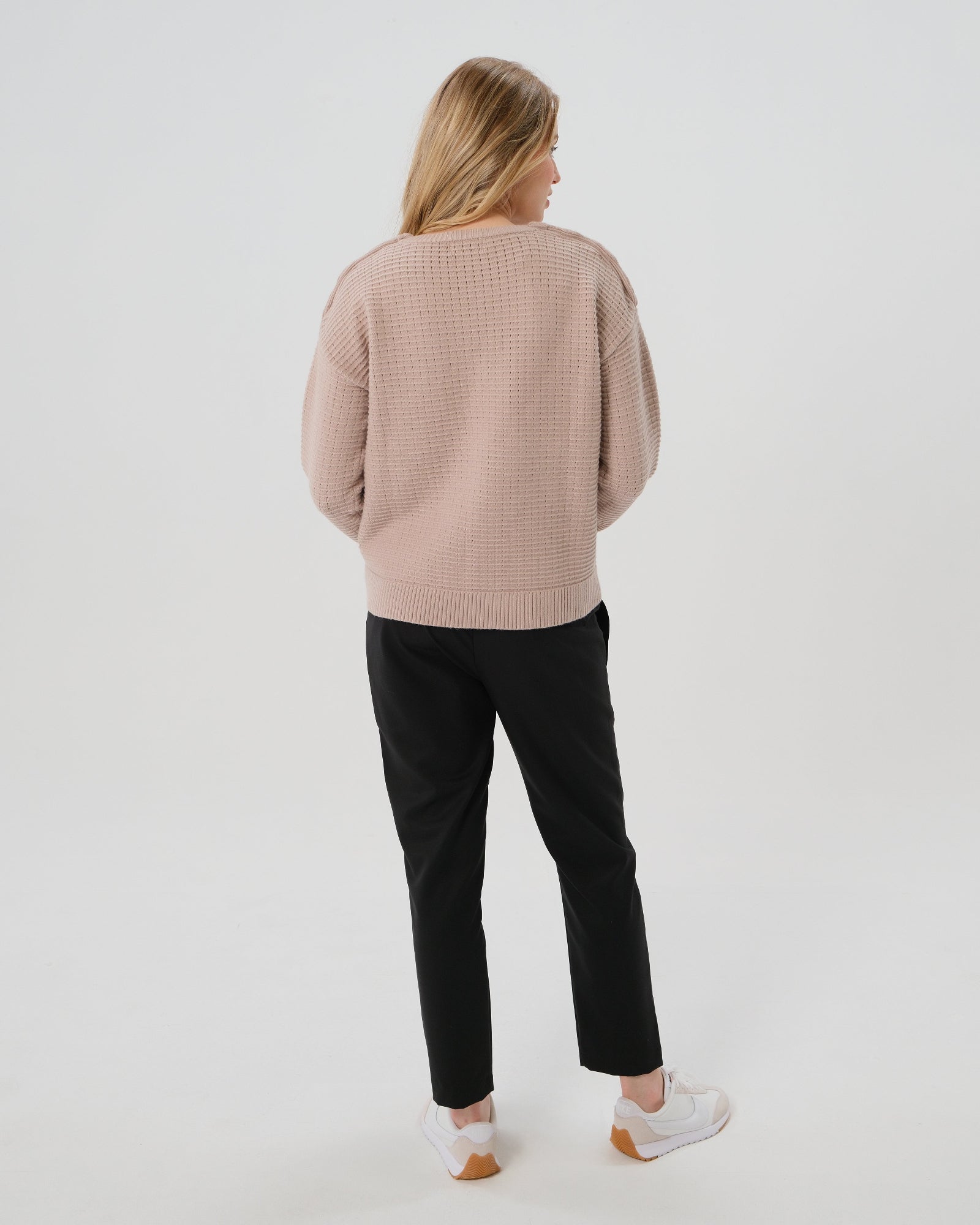 Black maternity pants, under belly style, cut in all-season wool blend with hidden flexible waist adjustment, deep pockets, and stylish straight leg. Maternity trousers cropped for tall mamas and full length for petite pregnant women. Postpartum friendly women's wear for business, wedding guest, dinner, and occasion. 