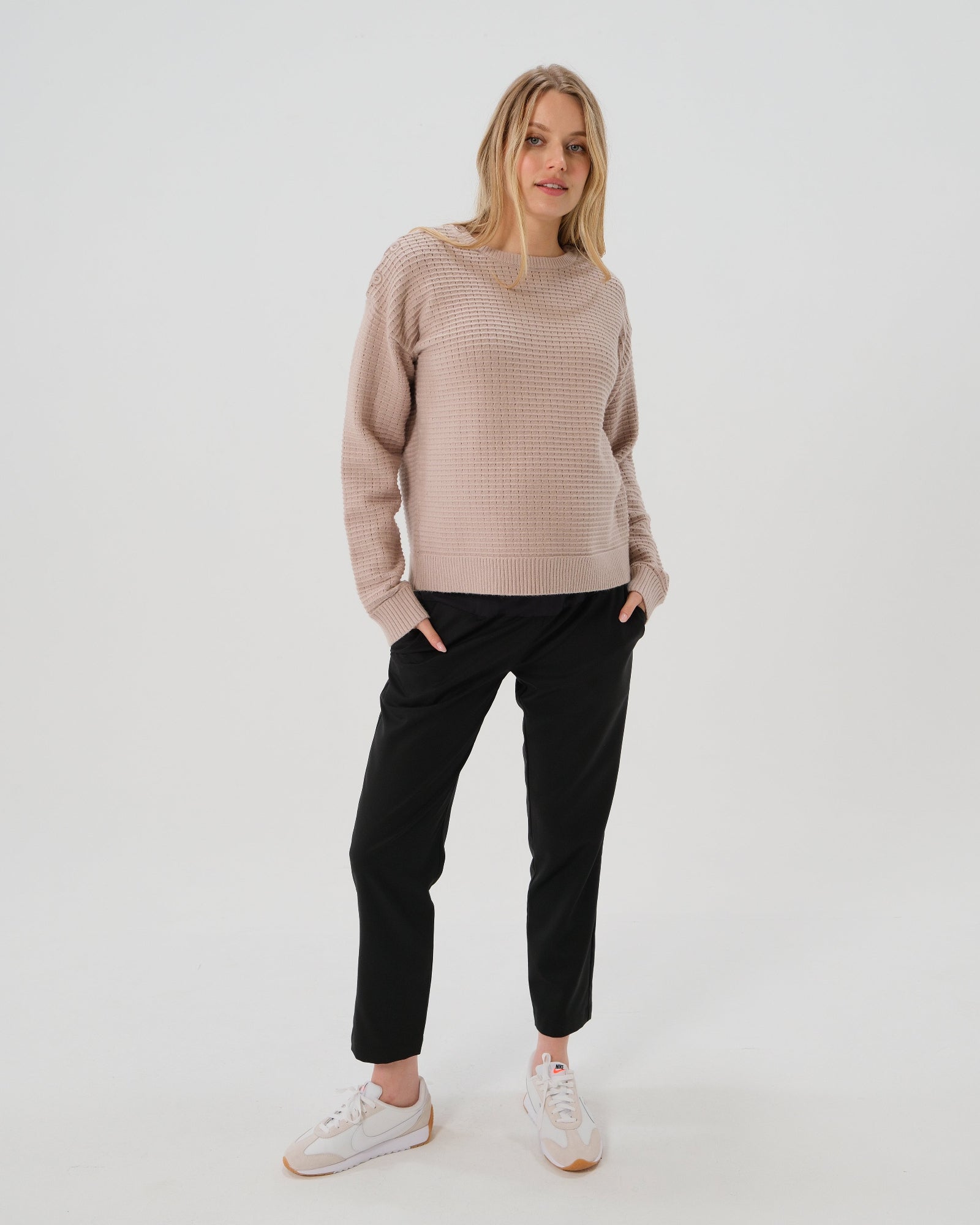 Black maternity pants, under belly style, cut in all-season wool blend with hidden flexible waist adjustment, deep pockets, and stylish straight leg. Maternity trousers cropped for tall mamas and full length for petite pregnant women. Postpartum friendly women's wear for business, wedding guest, dinner, and occasion.