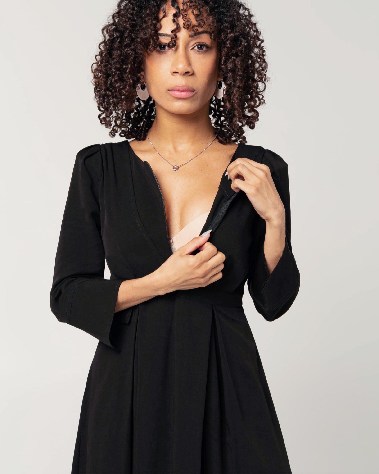 Black maternity and nursing empire dress for business, baby shower, wedding guest, party, and formal occasions. Sustainable TENCEL, zipper breastfeeding access, and full skirt with deep pockets. MARION offers the market&#39;s best maternity dresses in petite and standard sizes.