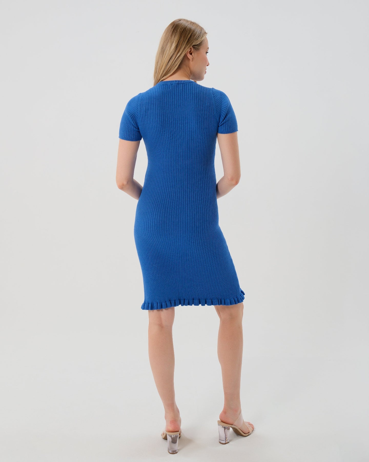 High end blue knee length knit maternity dress features breathable luxury stretch cotton knit, a feminine hem ruffle, and easy crew neck. Garnering exceptional reviews, this best-in-class design is petite and tall friendly and offered in standard and plus sizes up to 2x. Perfect maternity business attire, wedding guest dress, party outfit, baby shower style, or casual street wear. 2026 MARION core season collection. 