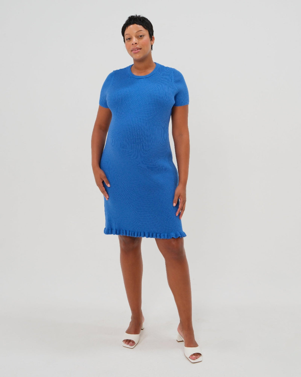 Woman wearing Marion textured short sleeve dress in vibrant blue. Tailored from soft stretch fabric with a flattering fitted silhouette and fringe hem. A polished, versatile piece perfect for work, brunch, or cocktail events.