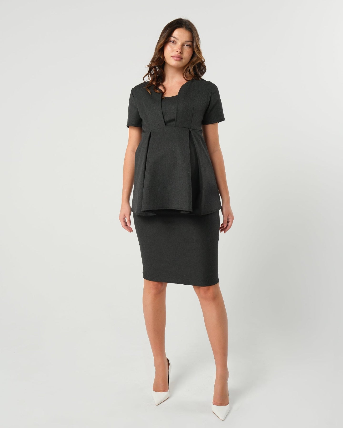 Charcoal gray premium maternity suit top separates, part of a corporate business maternity skirt or pant suit. This 5-star reviewed workwear top features nursing access for breastfeeding and pumping ease. The slimming and flattering Sloan blouse is cut with sustainable luxury Italian stretching suiting fabric, the Sloan is washable. Made for pregnant lawyers, executives, and even a business casual outfit. 
