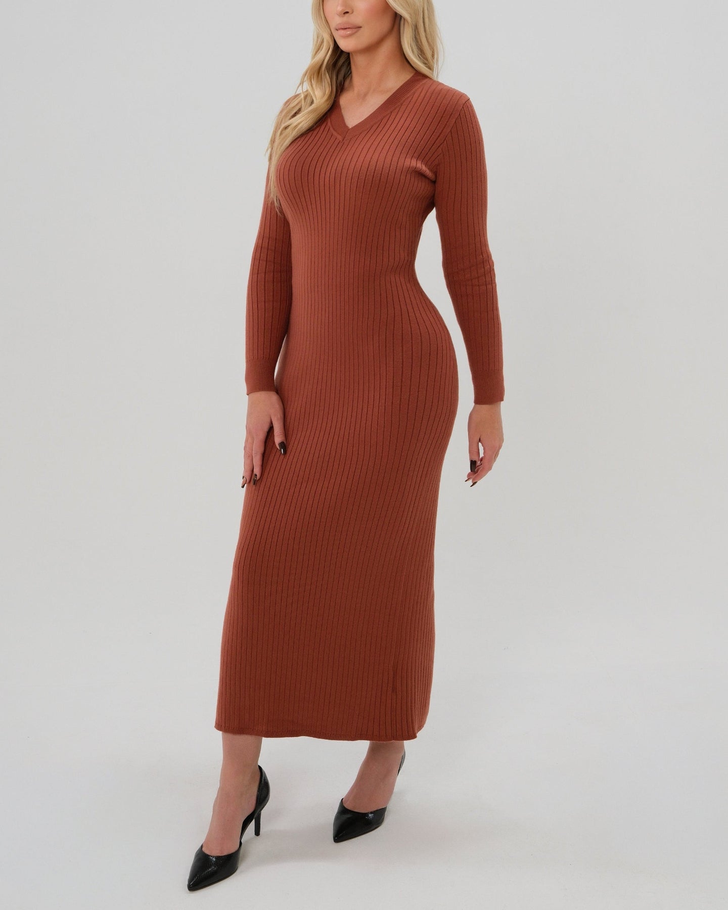 Woman wearing a high-end copper orange long sleeve maxi sweater dress with flattering v neck by MARION. Luxury high stretch cotton knit fabric. Our best reviewed dress for holidays, parties, wedding guest outfits, and fall and winter weather comfort. 