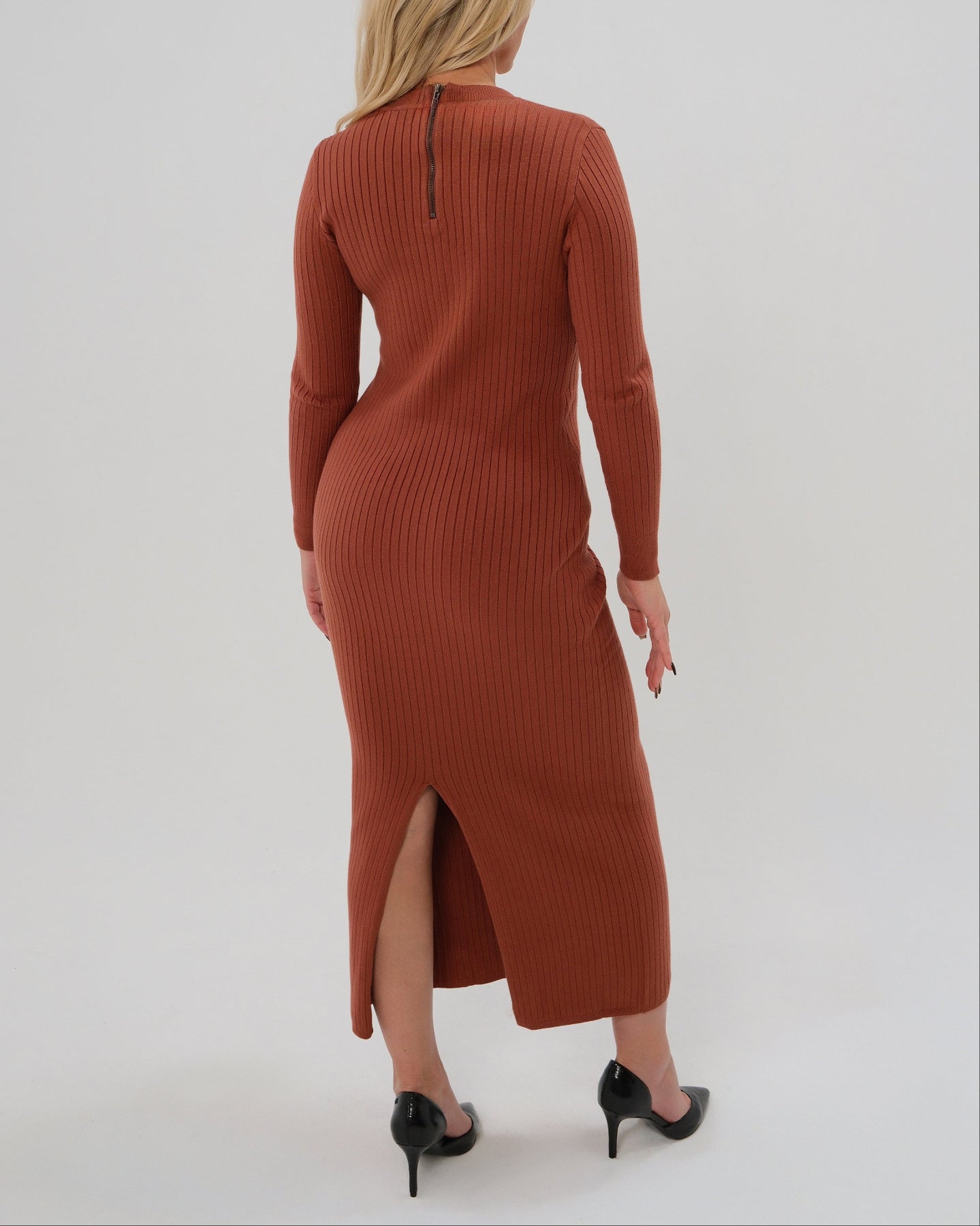 Woman wearing a high-end copper orange long sleeve maxi sweater dress with flattering v neck by MARION. Luxury high stretch cotton knit fabric. Our best reviewed dress for holidays, parties, wedding guest outfits, and fall and winter weather comfort. 