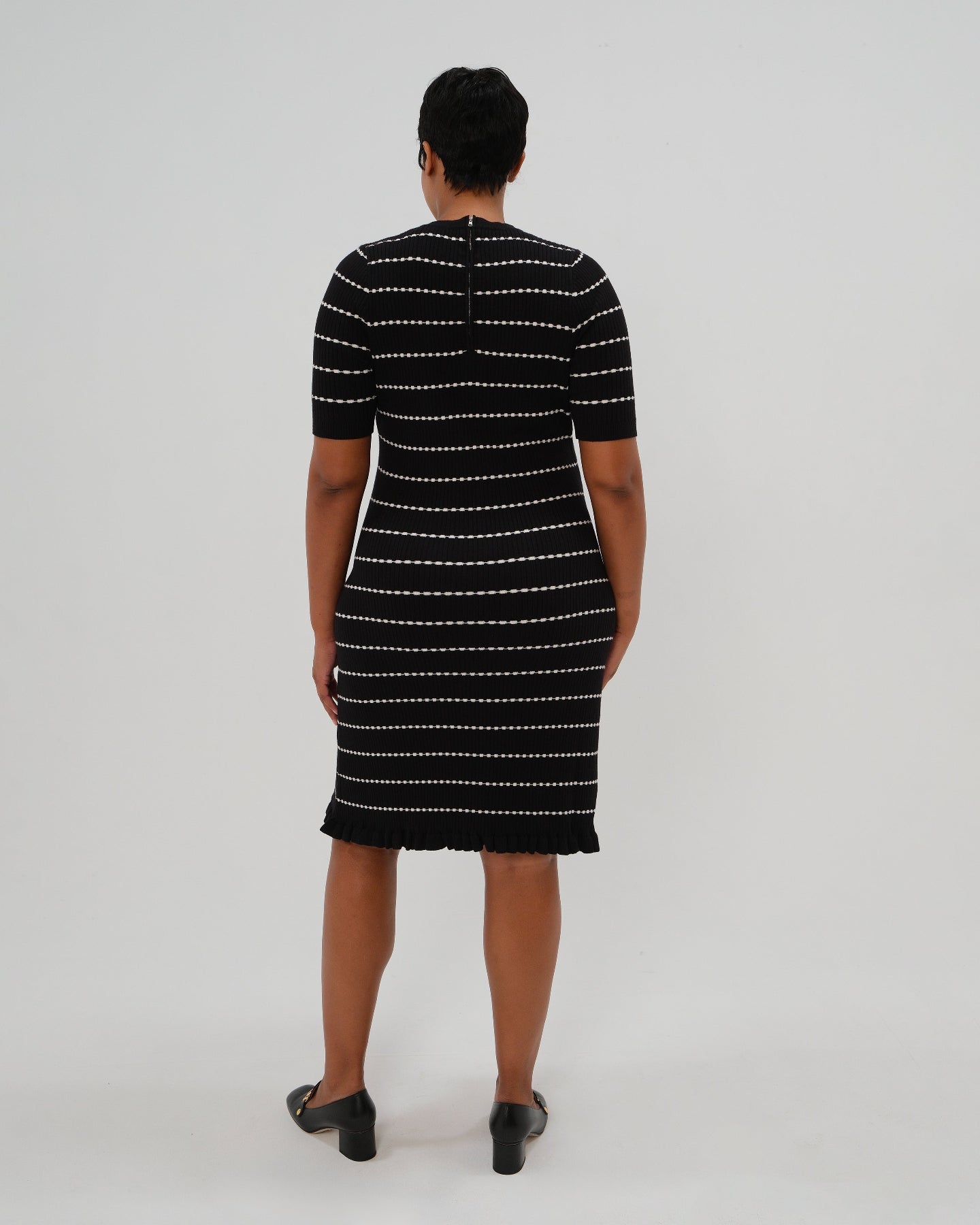 Best selling plus size knit maternity and nursing sweater dress in black and white stripes. This knee length dress features three-quarter sleeves with a feminine hem detail and a back zip for discreet breastfeeding access. Boasting countless 5-star reviews, this dress is ideal for maternity business workwear, date night, church, a wedding guest outfit, brunch, and occasion. For 2026, this style is petite and tall friendly, and offered in regular and plus size. Also available at Nordstrom, Bloomingdale&#39;s.
