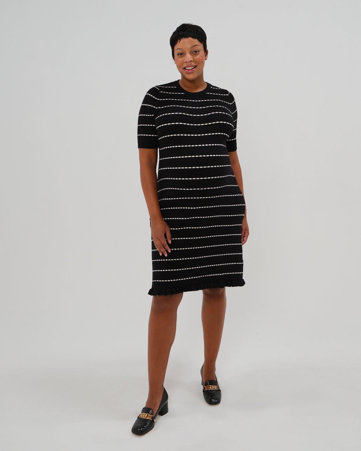 Best selling plus size knit maternity and nursing sweater dress in black and white stripes. This knee length dress features three-quarter sleeves with a feminine hem detail and a back zip for discreet breastfeeding access. Boasting countless 5-star reviews, this dress is ideal for maternity business workwear, date night, church, a wedding guest outfit, brunch, and occasion. For 2026, this style is petite and tall friendly, and offered in regular and plus size. Available at Nordstrom, Bloomingdale's.