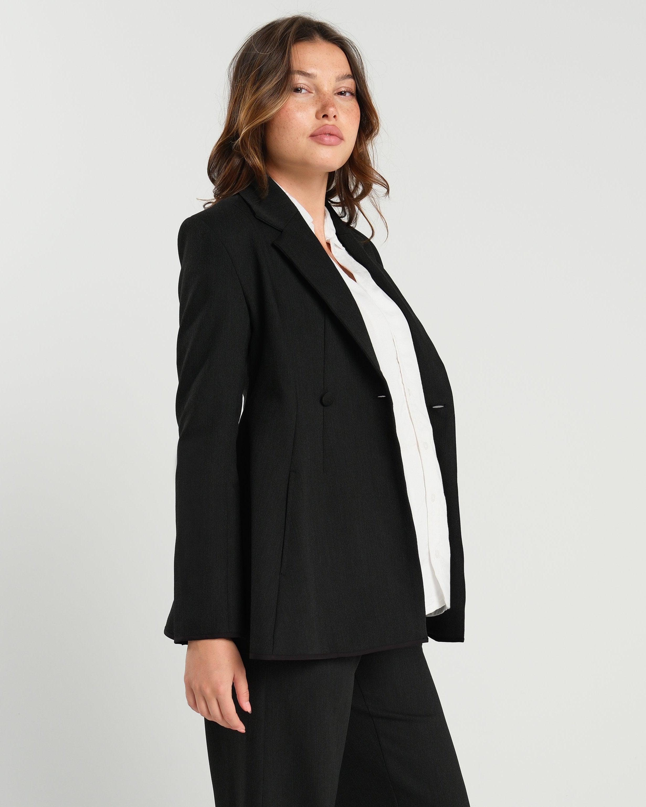 Black maternity blazer suit jacket in luxury Italian stretch suiting fabric. Empire waist pant suit separates for your best pregnancy, breastfeeding, and postpartum fit. Petite and regular sizes. 38% sustainable recycled fibers. Also sold by Nordstrom, Bloomingdale's, and Macy's maternity. 