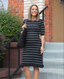 Petite pregnant model wearing bestselling knit maternity and nursing sweater dress in black & white stripes. This knee length dress features three-quarter sleeves with a feminine hem detail and back zip for discreet breastfeeding access. Boasting countless 5-star reviews, this dress is ideal for maternity business wear, date night, church, wedding guest outfit, brunch, and occasion. For 2026, this style is petite and tall friendly, offered in regular and plus size. Available at Nordstrom, Bloomingdale's.