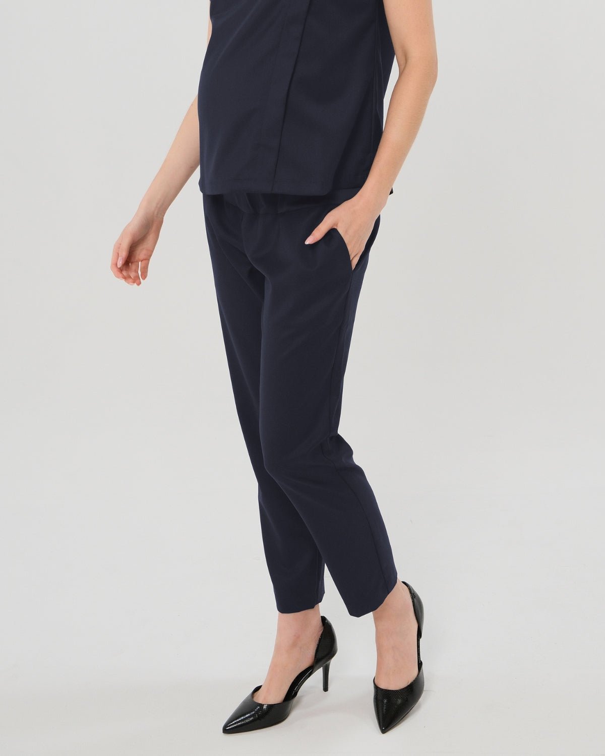 Navy maternity all-season wool blend under belly trousers with hidden flexible waist adjustment, deep pockets, and stylish straight leg. Pant cropped for tall mamas and full length for petite pregnant women. Postpartum friendly women's wear for business, wedding guest, dinner, and occasion.