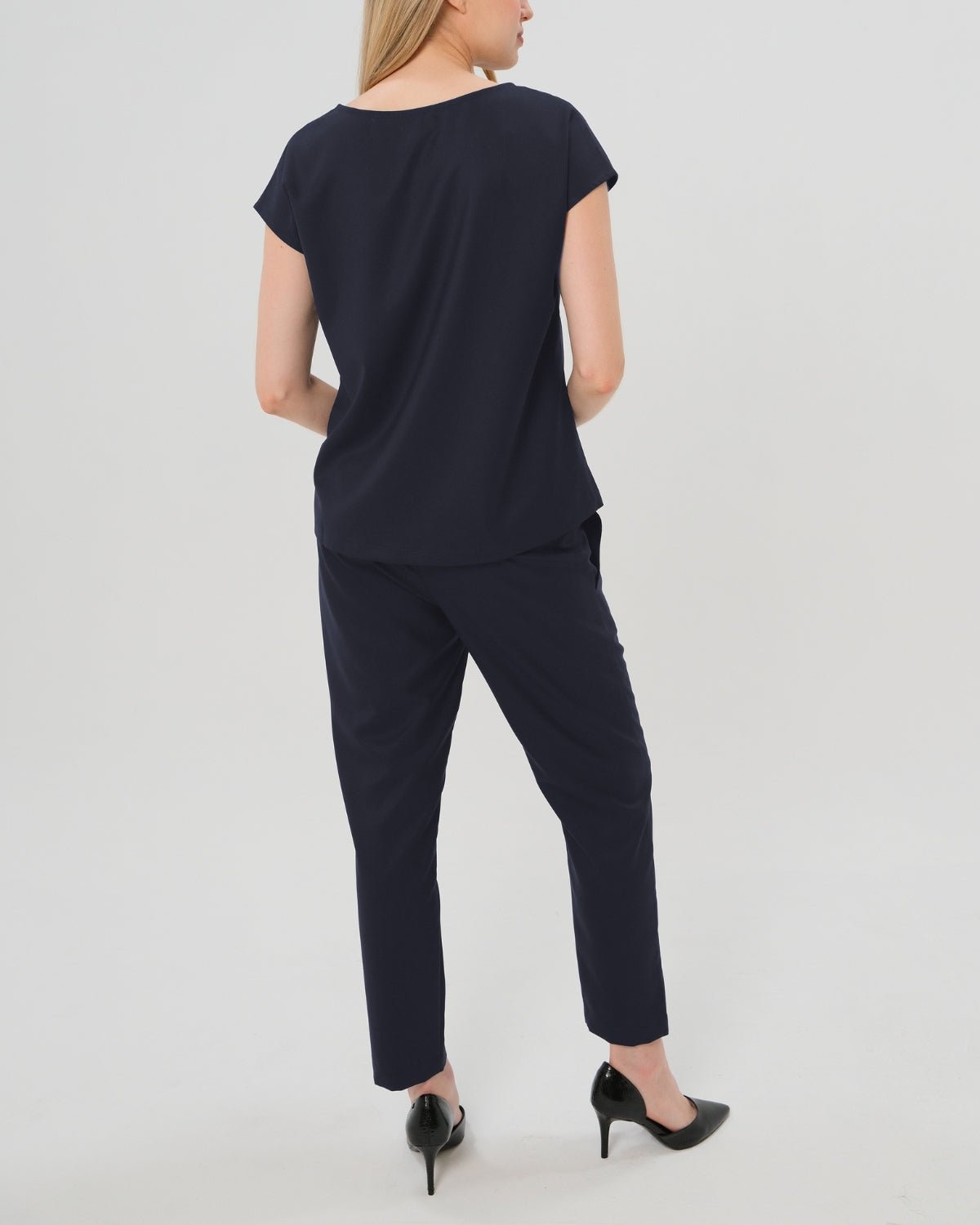 Navy maternity all-season wool blend under belly trousers with hidden flexible waist adjustment, deep pockets, and stylish straight leg. Pant cropped for tall mamas and full length for petite pregnant women. Postpartum friendly women's wear for business, wedding guest, dinner, and occasion. 