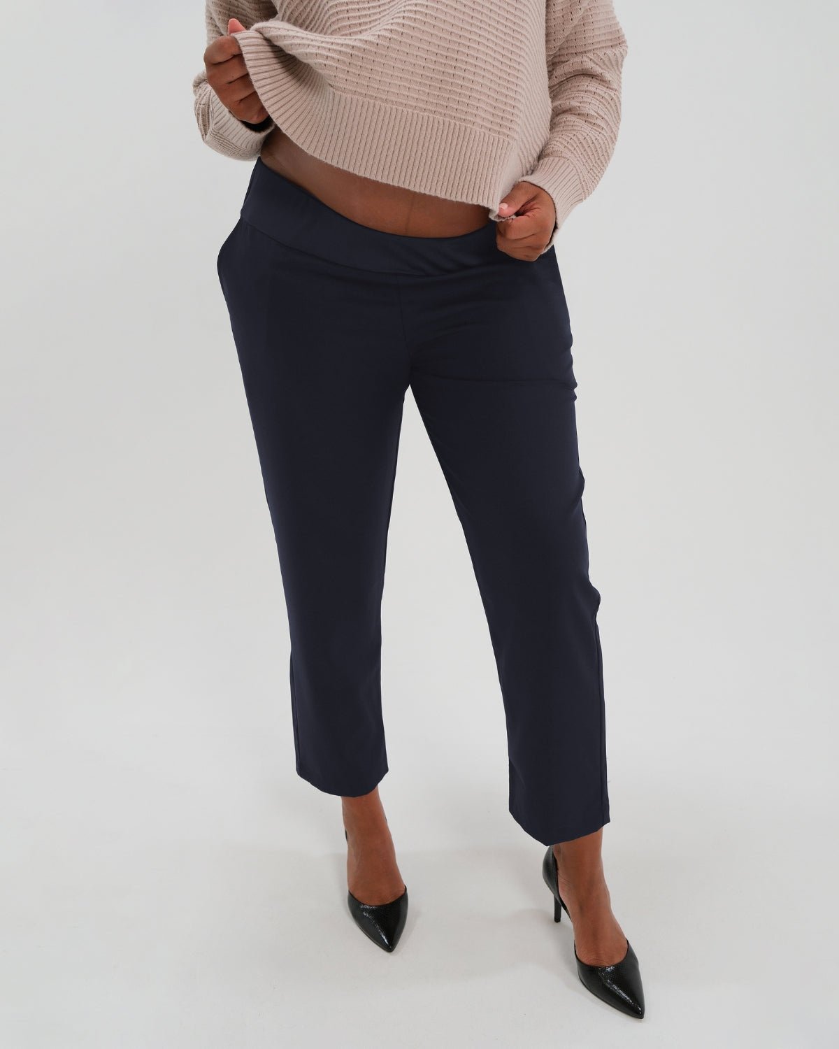 Navy maternity all-season wool blend under belly trousers with hidden flexible waist adjustment, deep pockets, and stylish straight leg. Pant cropped for tall mamas and full length for petite pregnant women. Postpartum friendly women's wear for business, wedding guest, dinner, and occasion. 