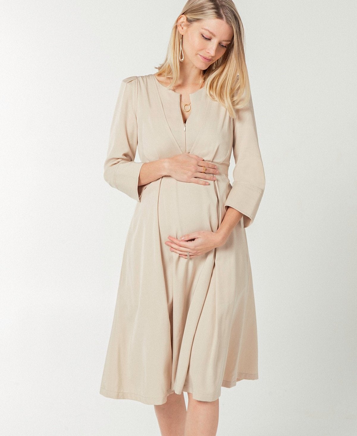 Beige maternity and nursing empire dress for business, baby shower, wedding guest, party, and formal occasions. Sustainable TENCEL, zipper breastfeeding access, and full skirt with deep pockets. MARION offers the market's best maternity dresses in petite and standard sizes.