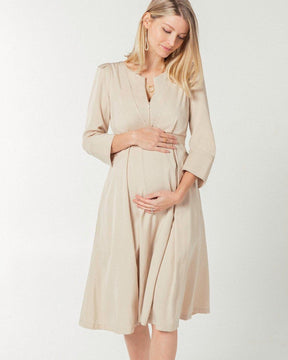 Beige maternity and nursing empire dress for business, baby shower, wedding guest, party, and formal occasions. Sustainable TENCEL, zipper breastfeeding access, and full skirt with deep pockets. MARION offers the market's best maternity dresses in petite and standard sizes.