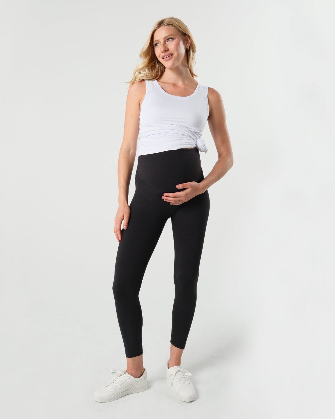 Black MARION maternity leggings with cell phone pocket, made of soft, luxury recycled nylon for pregnancy comfort. Petite friendly maternity pants.