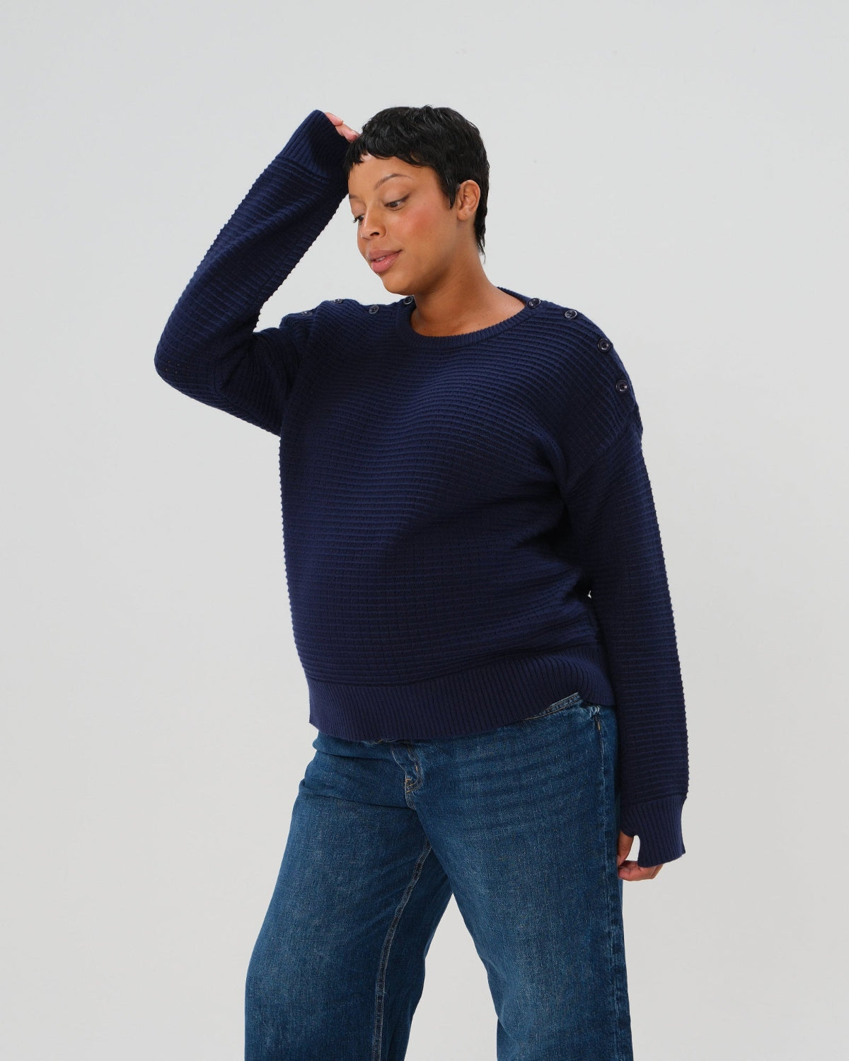 Navy premium maternity and nursing sweater in stretch cotton box knit. Featuring shoulder button detail for breastfeeding and discreet hem thumbholes for an extra cozy fit. Oversized fit is flattering, polished, and versatile - transitioning from pregnancy workwear to loungewear to streetwear with ease. Petite and tall friendly; available in regular and plus size. 