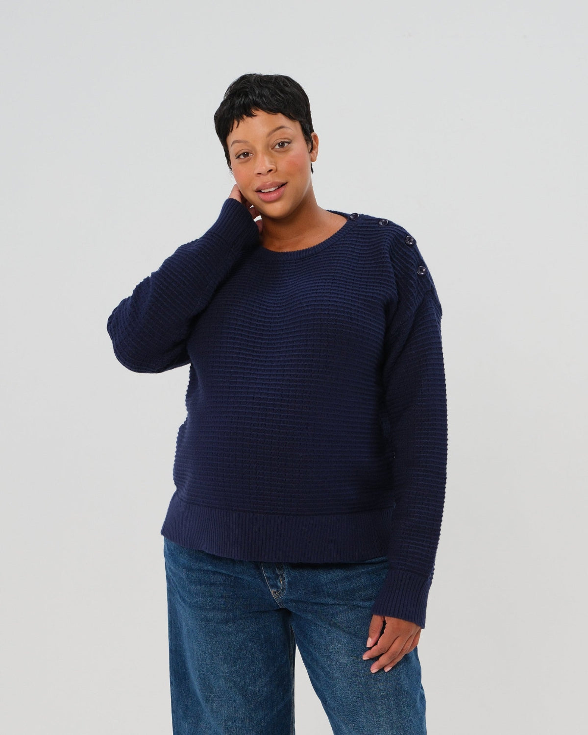 Navy premium maternity and nursing sweater in stretch cotton box knit. Featuring shoulder button detail for breastfeeding and discreet hem thumbholes for an extra cozy fit. Oversized fit is flattering, polished, and versatile - transitioning from pregnancy workwear to loungewear to streetwear with ease. Petite and tall friendly; available in regular and plus size. 