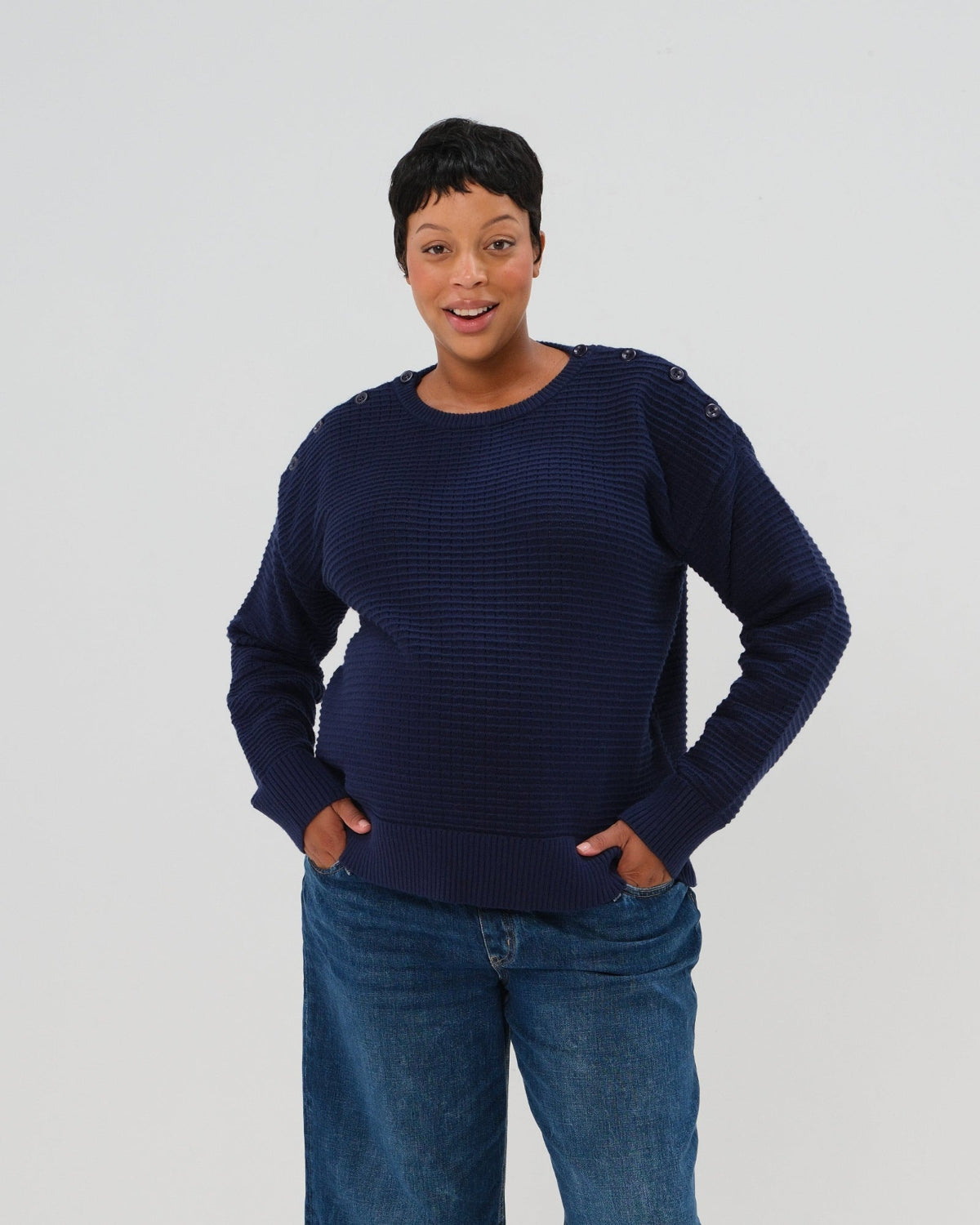 Navy premium maternity and nursing sweater in stretch cotton box knit. Featuring shoulder button detail for breastfeeding and discreet hem thumbholes for an extra cozy fit. Oversized fit is flattering, polished, and versatile - transitioning from pregnancy workwear to loungewear to streetwear with ease. Petite and tall friendly; available in regular and plus size. 